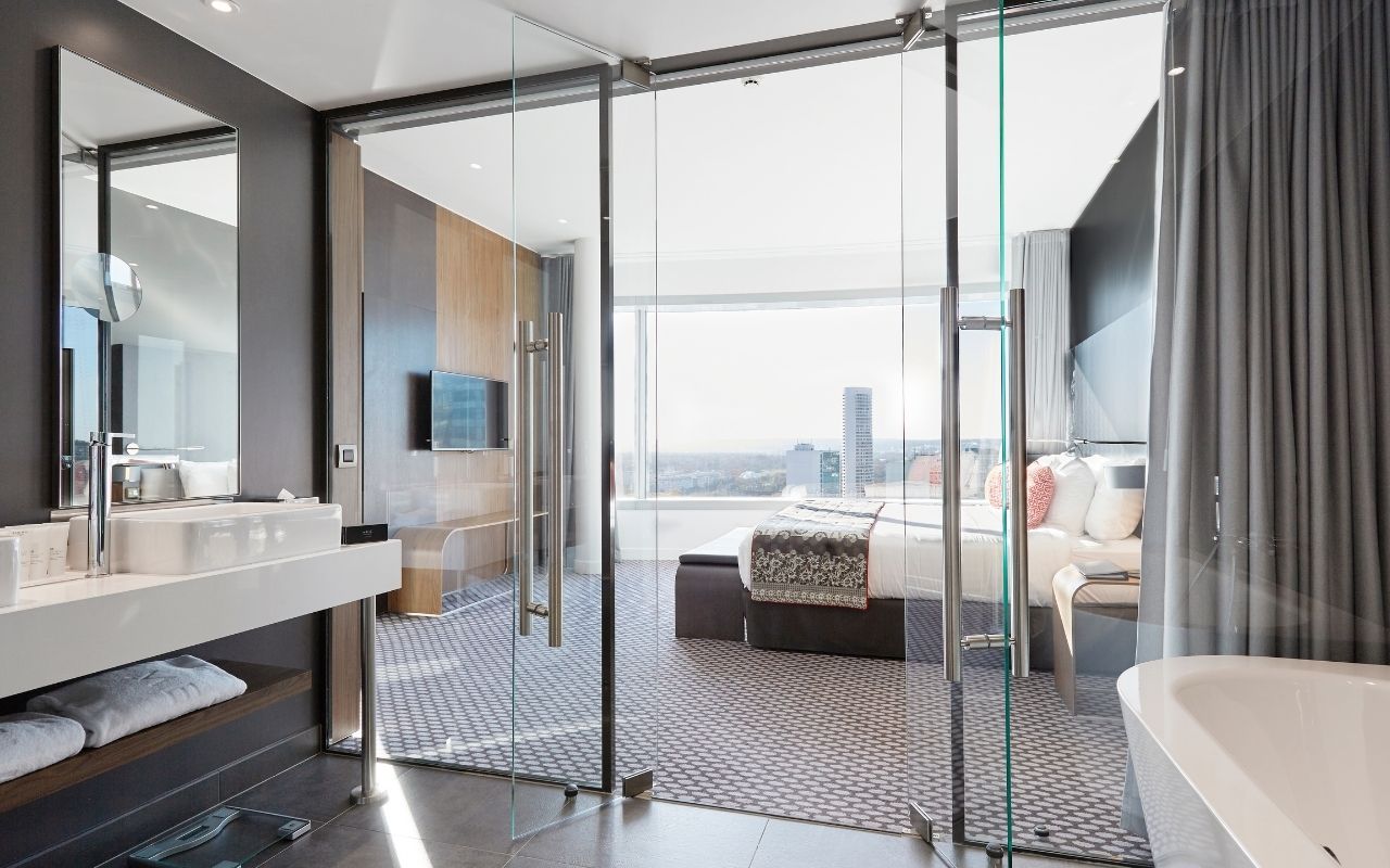 Bathroom of the luxury hotel Le Melia at La Défense in Paris designed by the interior design studio jean-philippe nuel, view on Paris, bathroom open on the room, bright interior design, chic interior design