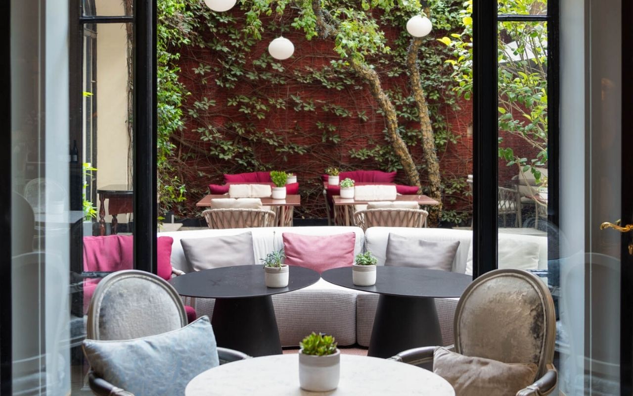 Outdoor terrace of the luxury hotel Lancaster in Paris, chic and glamorous atmosphere, luxury hotel designed by the interior design studio jean-philippe nuel