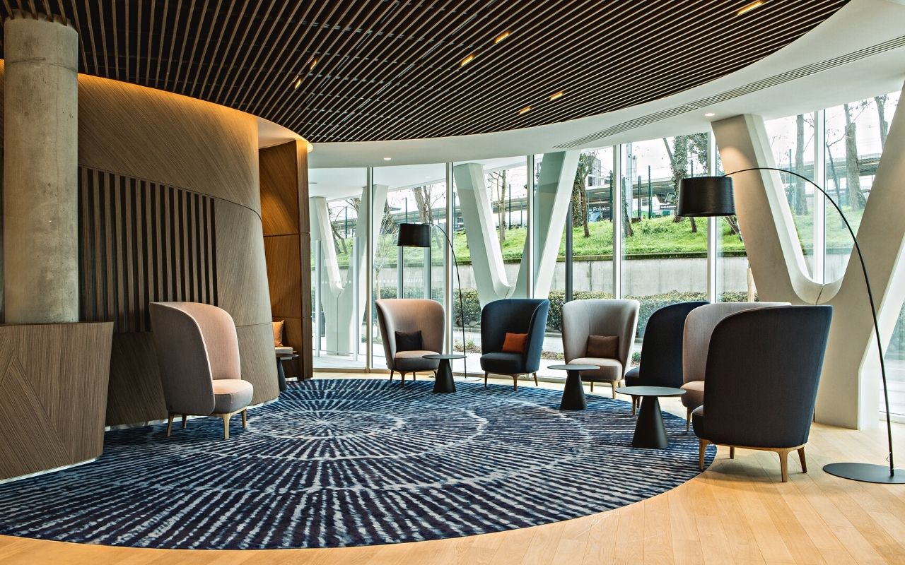 Reception hall of the Danone headquarters in the Convergence building designed by the interior architecture studio jean-philippe nuel with Ligne Roset armchairs