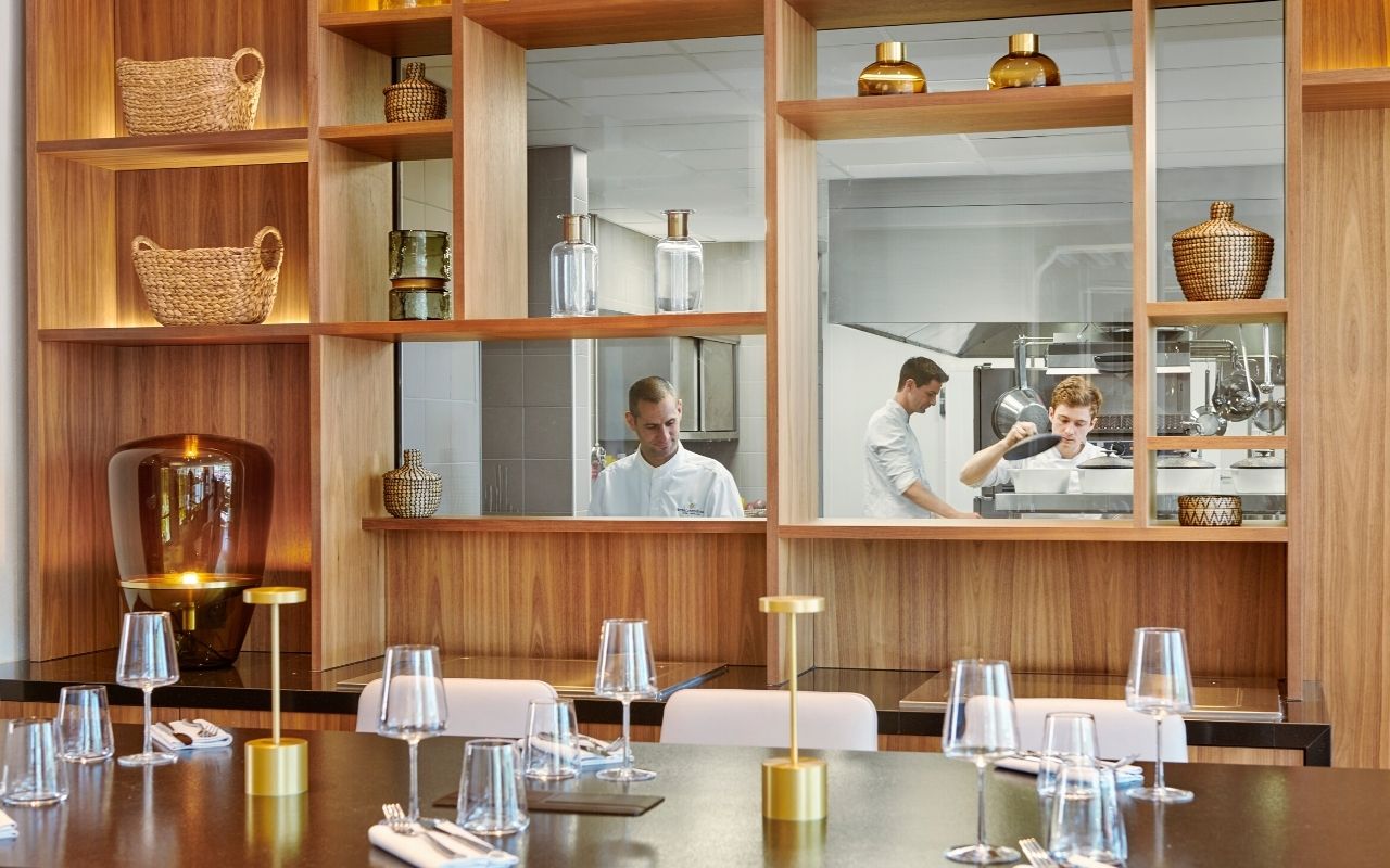View of the cooks at the stove in the Restaurant Epona of the InterContinental Lyon Hotel Dieu designed by the French interior design studio jean-philippe nuel