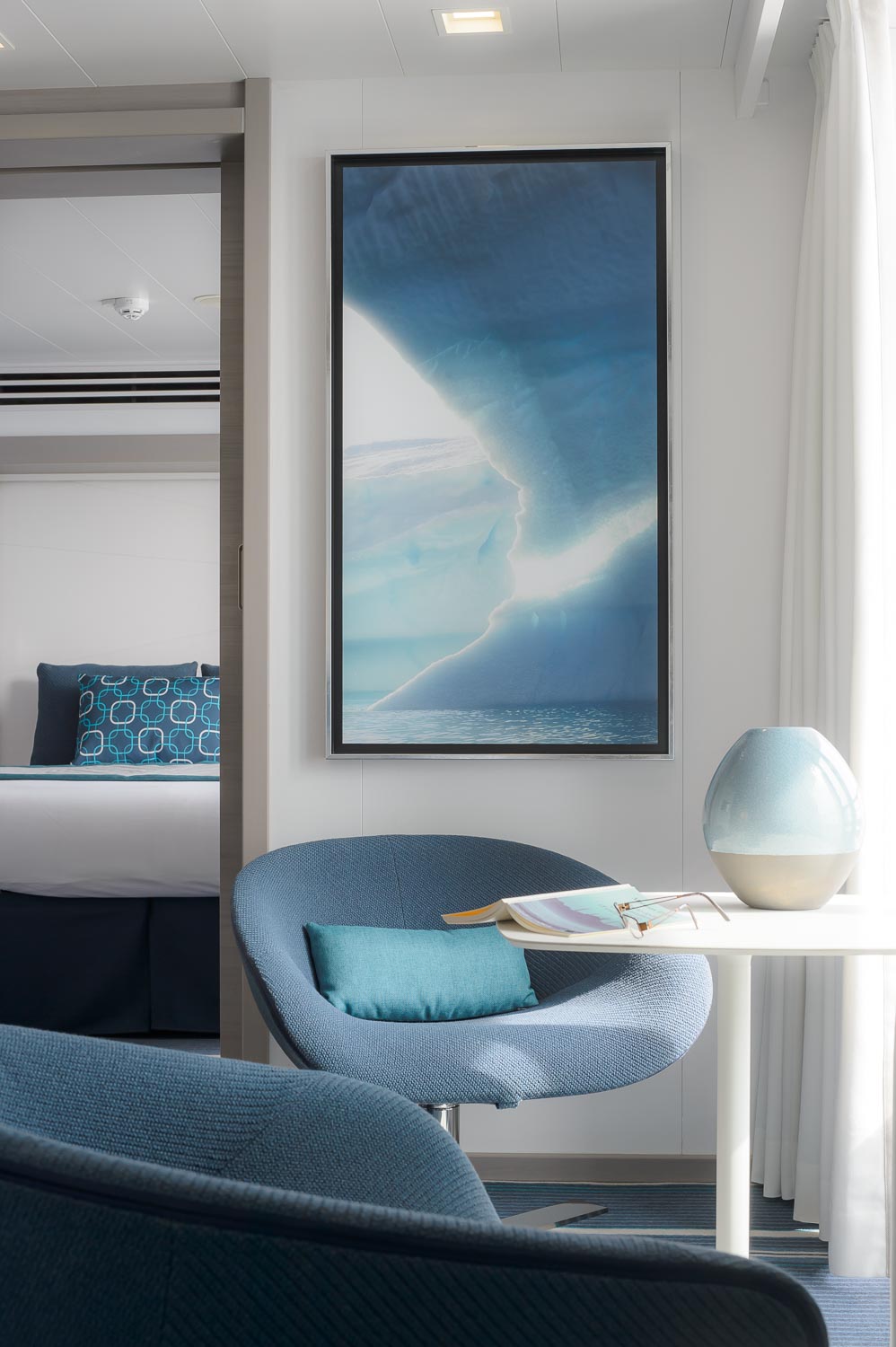 Room with the maritime colors of the luxury cruise ships the sisterships of the Ponant company designed by the interior design studio jean-philippe nuel with decoration and artworks
