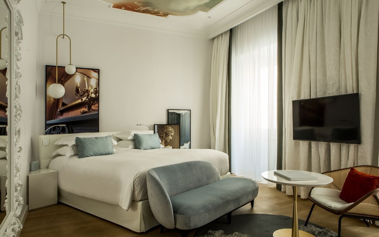 Decoration of the luxury room with paintings on the ceiling of the Hotel Sofitel Rome Villa Borghese designed by the French interior design studio Jean-Philippe Nuel