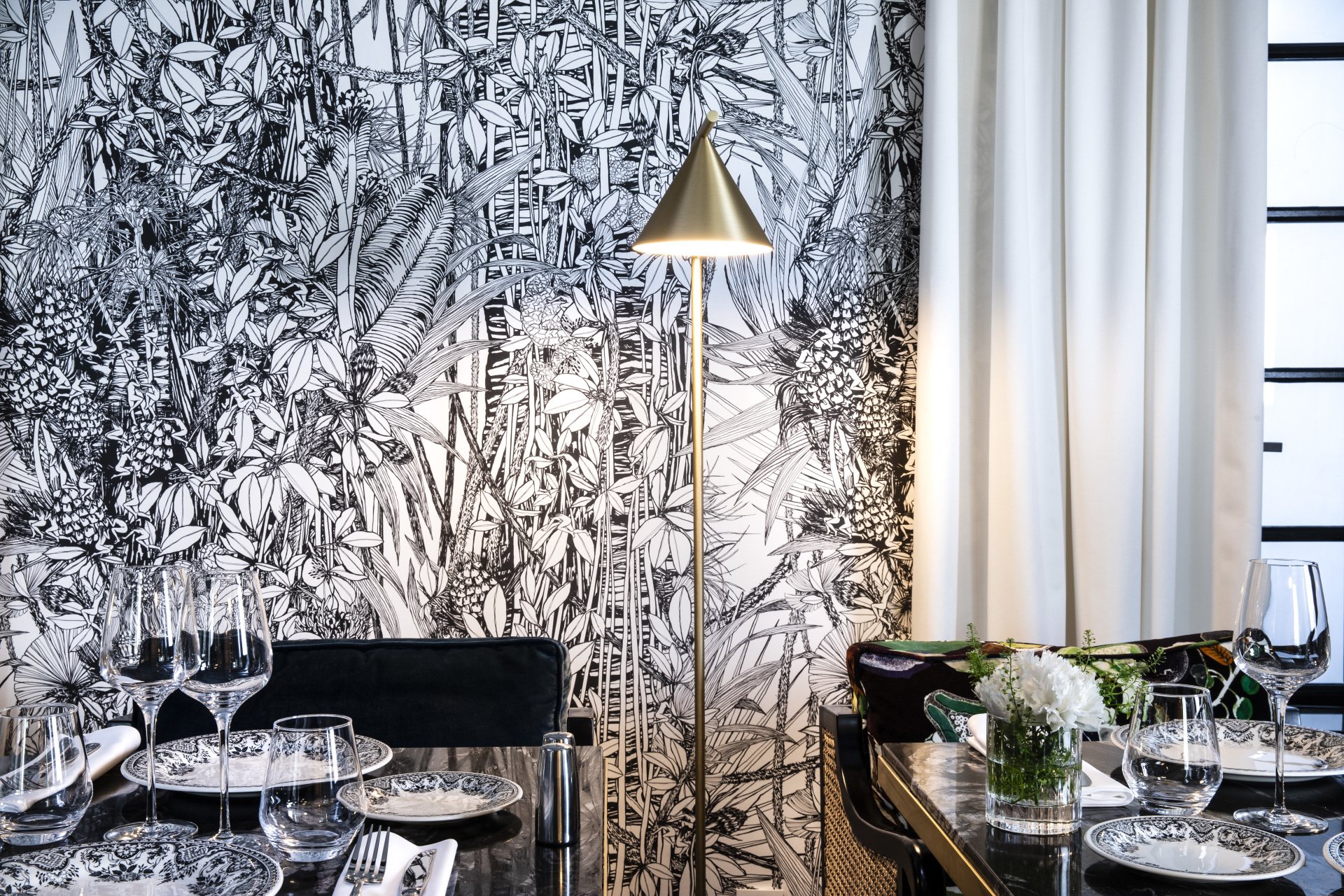 Atypical winter garden decoration with flowered wallpaper in the restaurant of the hotel Le Damantin in Paris designed by the french interior design studio jean-philippe nuel
